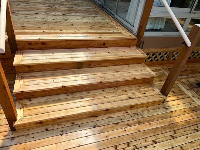 Rebuilt cedar deck stairs with new treads and risers for improved safety on a custom deck in Renton, WA.
