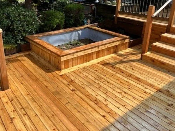 Custom cedar planter box built into a cedar deck in Renton, WA with matching decking and trim.