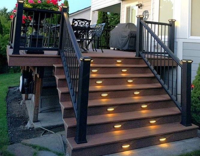 Deck renovation and remodeling with composite decking, aluminum railings, integrated stair lighting, and upgraded stairs in King County, WA.