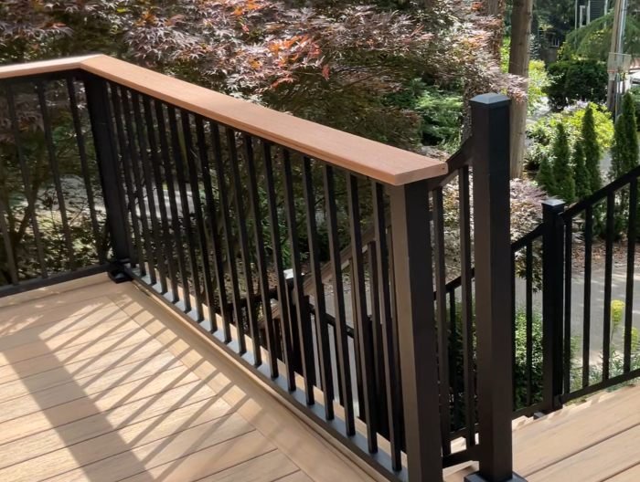 Composite decking with black metal railing installed on residential deck in Renton WA for durability and low maintenance