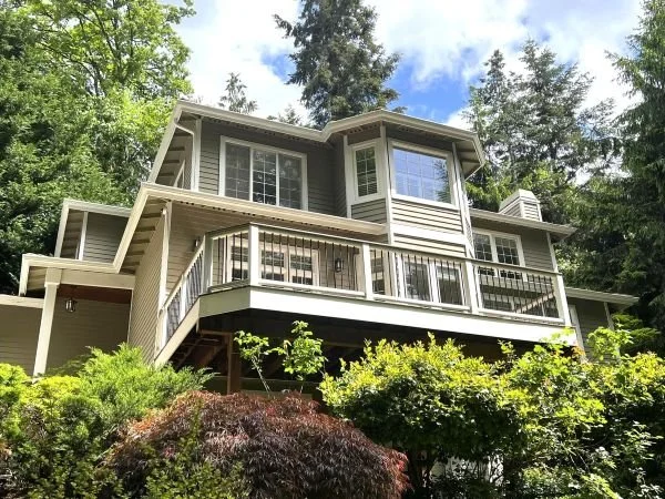 Elevated deck construction with integrated guardrails and structural framing