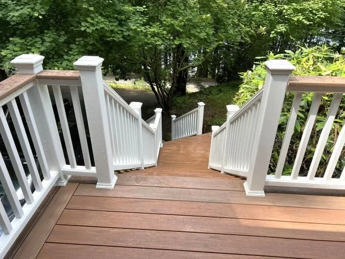 Multi-level deck staircase with integrated railings and landing transitions built into a sloped yard
