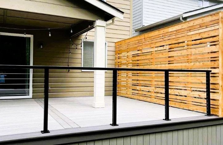 Composite deck construction with black railing and covered area in Kent, WA