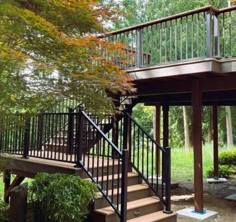 Custom composite deck with aluminum railing and stairs built by Petra Decks for a hillside home in Sammamish, WA.