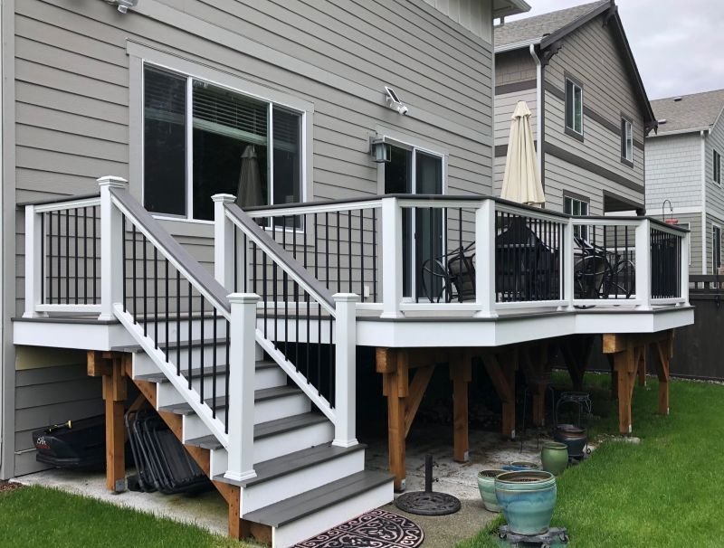 Elevated composite deck with stairs and railing for a Black Diamond home