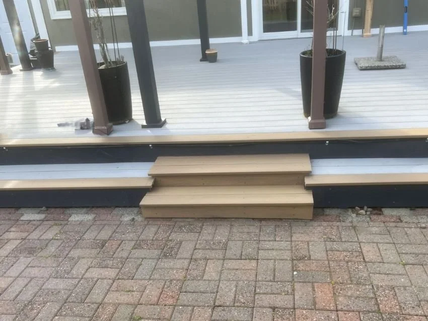 Finished deck stairs installation in Kent providing safe access from deck to patio area