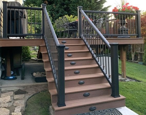 Deck remodeling project in King County, WA featuring upgraded composite stairs, modern black railing system, and improved outdoor usability without full structural replacement