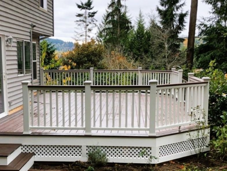 Full perimeter deck railing installation with evenly spaced vertical balusters