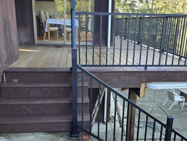 Deck replacement with composite decking, new stairs, and black railing system