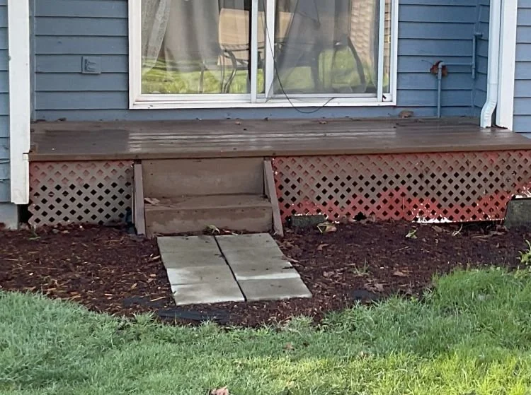 Old deck in Auburn, WA showing worn stairs, aging decking boards, and structural deterioration before replacement