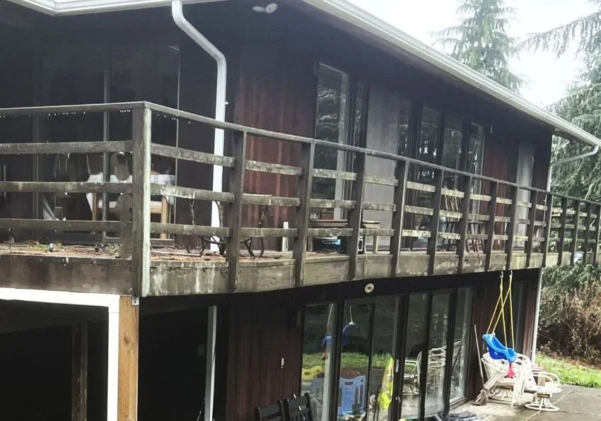 Aging elevated wood deck in Maple Valley showing worn boards and structural deterioration before full deck replacement