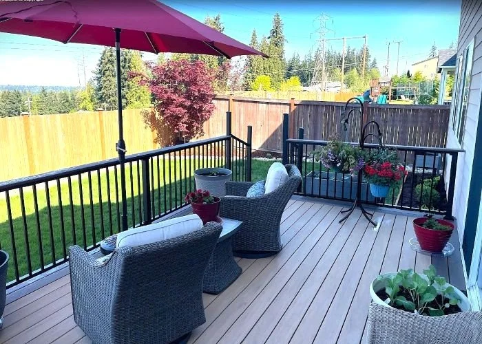 Composite deck construction in Renton WA with metal railing and backyard seating area designed for durability and outdoor use