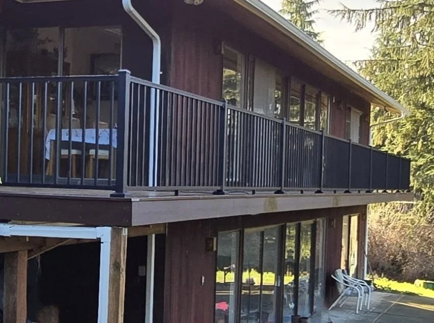 Newly rebuilt elevated deck in Maple Valley with updated framing and black railing system after full deck replacement