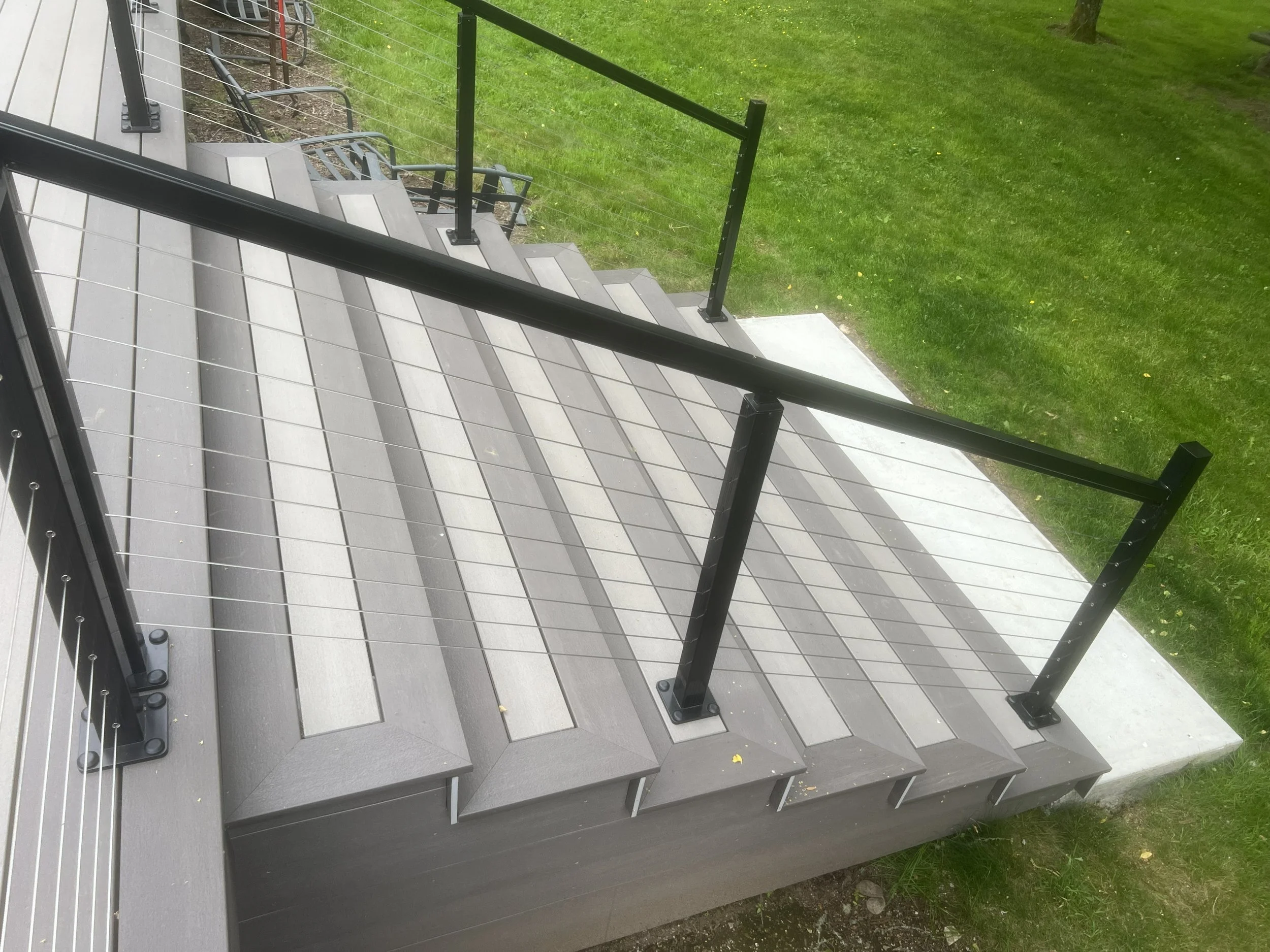 PVC deck stair remodeling project with black cable railings and improved backyard access in Maple Valley WA