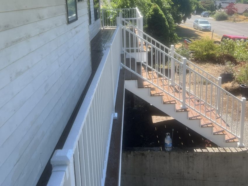 Trex composite deck with white aluminum railing and rebuilt stairs in Renton, WA