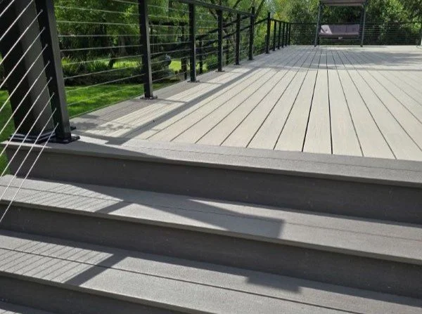 Completed PVC deck replacement in Maple Valley featuring Fiberon Promenade decking, picture-frame border, and RailFX stainless steel cable railing.