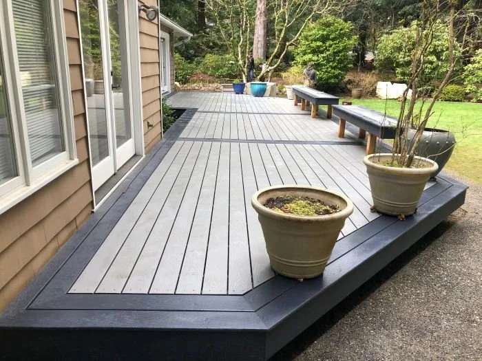 Custom composite deck construction project in Redmond, WA with low-maintenance decking, integrated bench seating, and clean modern layout designed for long-term outdoor usability.