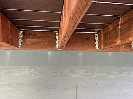 Deck structural evaluation showing joists, connectors, and load-bearing hardware