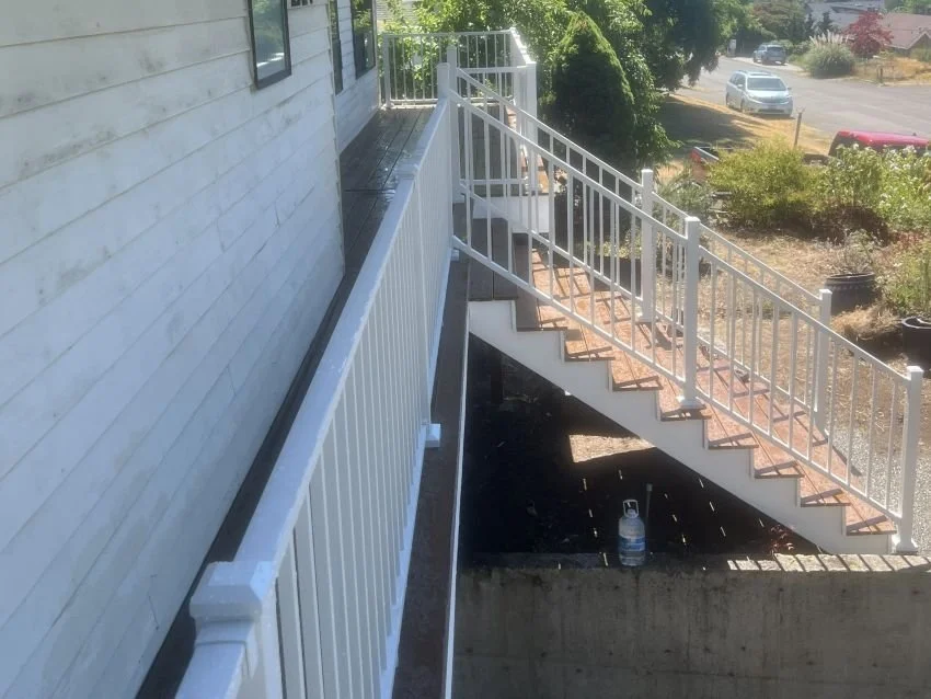 Trex composite deck with white aluminum railing and rebuilt stairs in Renton, WA