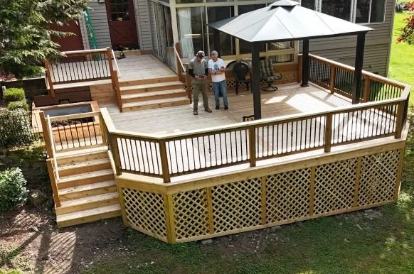 Completed cedar deck and stair replacement project in Renton, WA featuring new cedar decking, rebuilt stairs, planter box, wood railing, and lattice skirting.