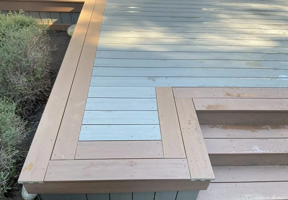 Composite deck with a two-tone picture-frame border installed by Petra Decks for a homeowner in Black Diamond, WA.