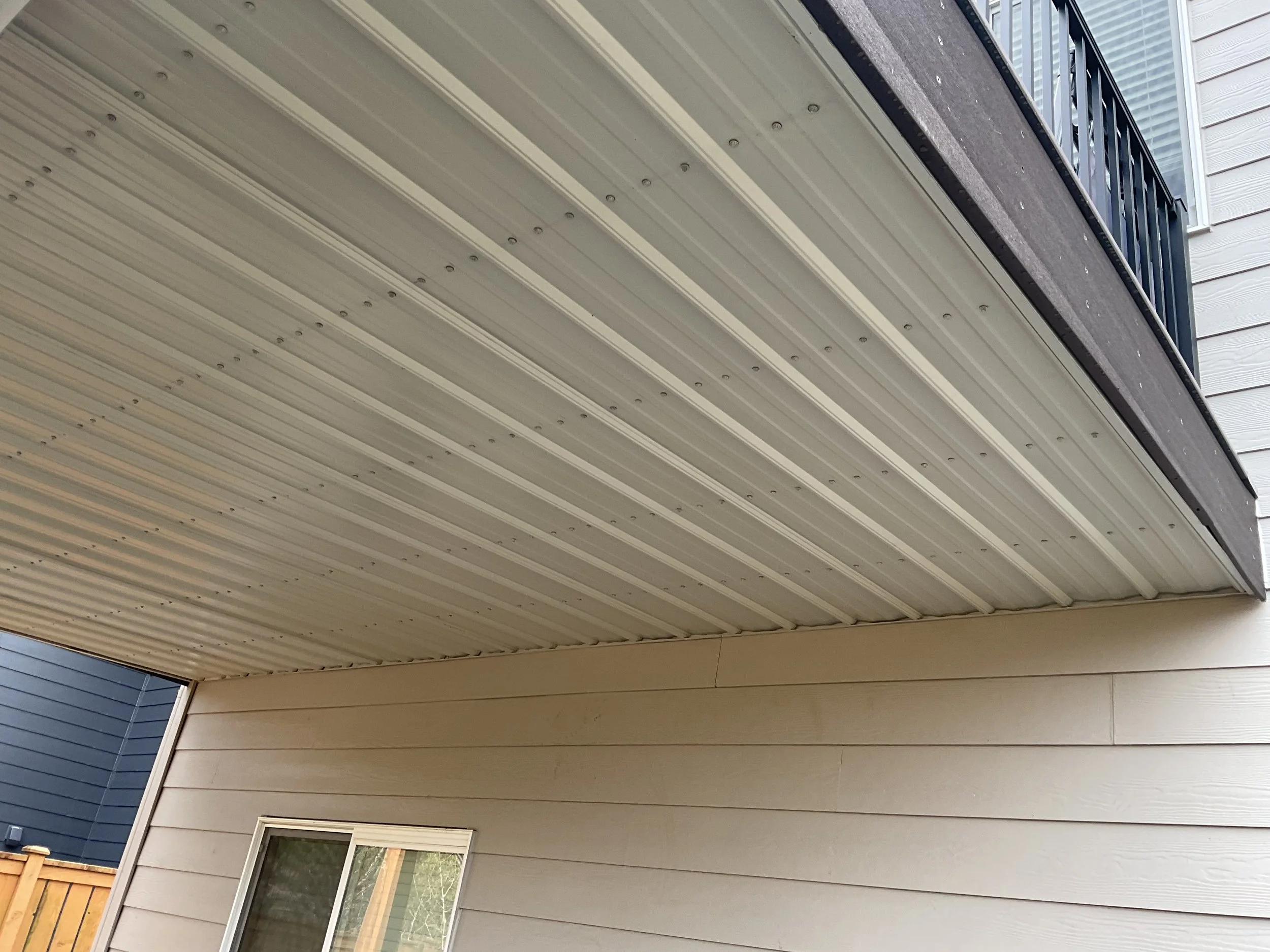 Finished under-deck waterproofing ceiling beneath an existing deck
