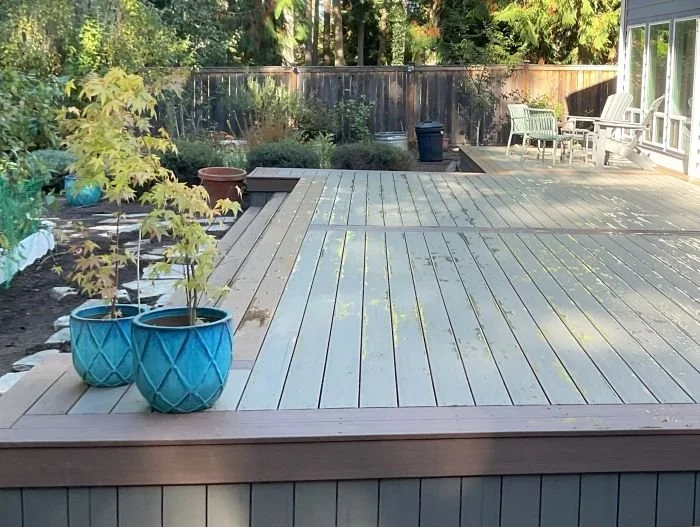 Sammamish composite deck with picture-frame trim, vertical skirting, and integrated landscaping