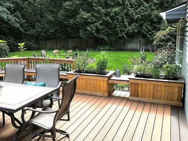 Built-in deck planter boxes defining outdoor seating area