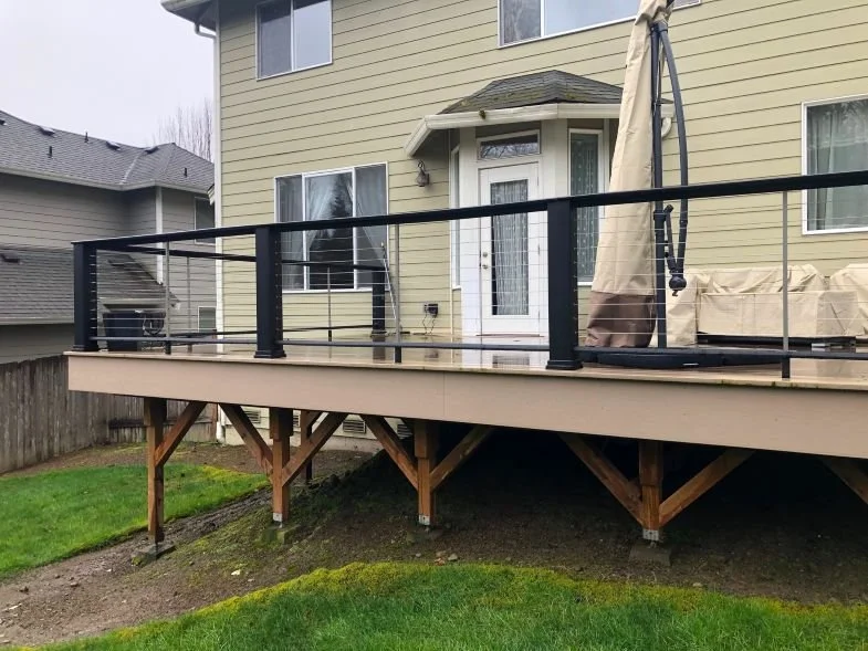 Low to mid-height residential deck showing posts, footings, and ground clearance
