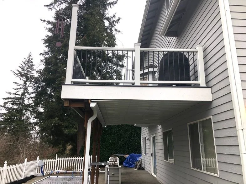 Finished under-deck waterproofing system creating a dry, usable area beneath an elevated deck