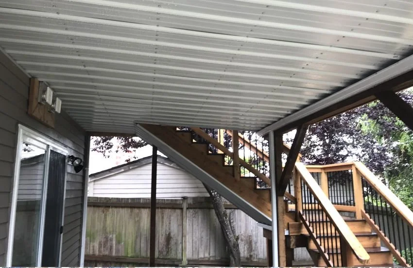 Under-deck waterproofing system installed beneath an existing elevated deck