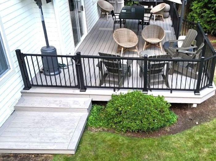 Custom composite deck expansion with aluminum railings designed to create a larger outdoor living and entertaining space for a King County homeowner.