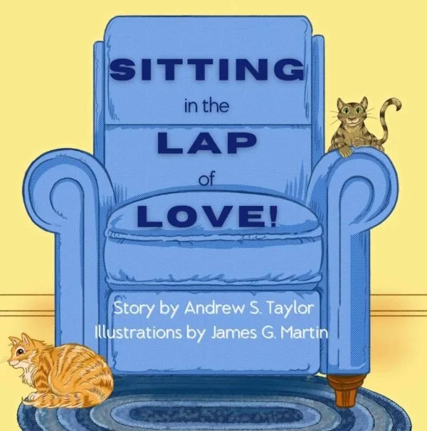 Cover of a children's book titled "Sitting in the Lap of Love" featuring a blue armchair with a cat sitting on one arm and another cat on the floor beside it.
