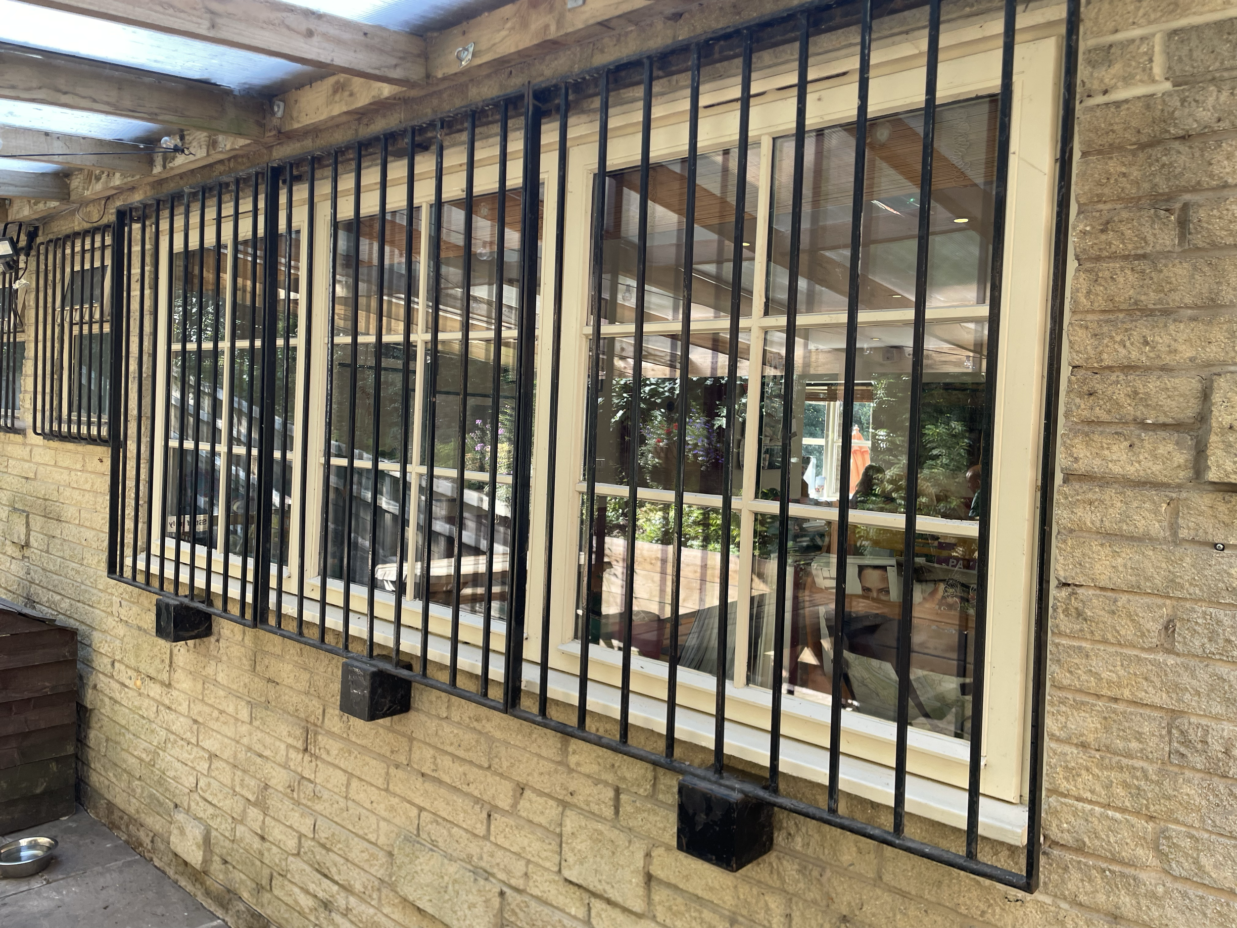 Our old bars which we have since replaced. These were too heavy to remove daily so remained on the windows for trade