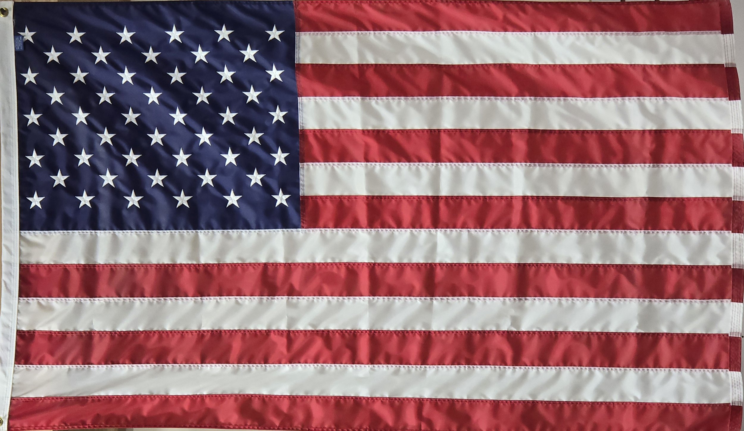 American flag with stars on a blue canton and red and white stripes.