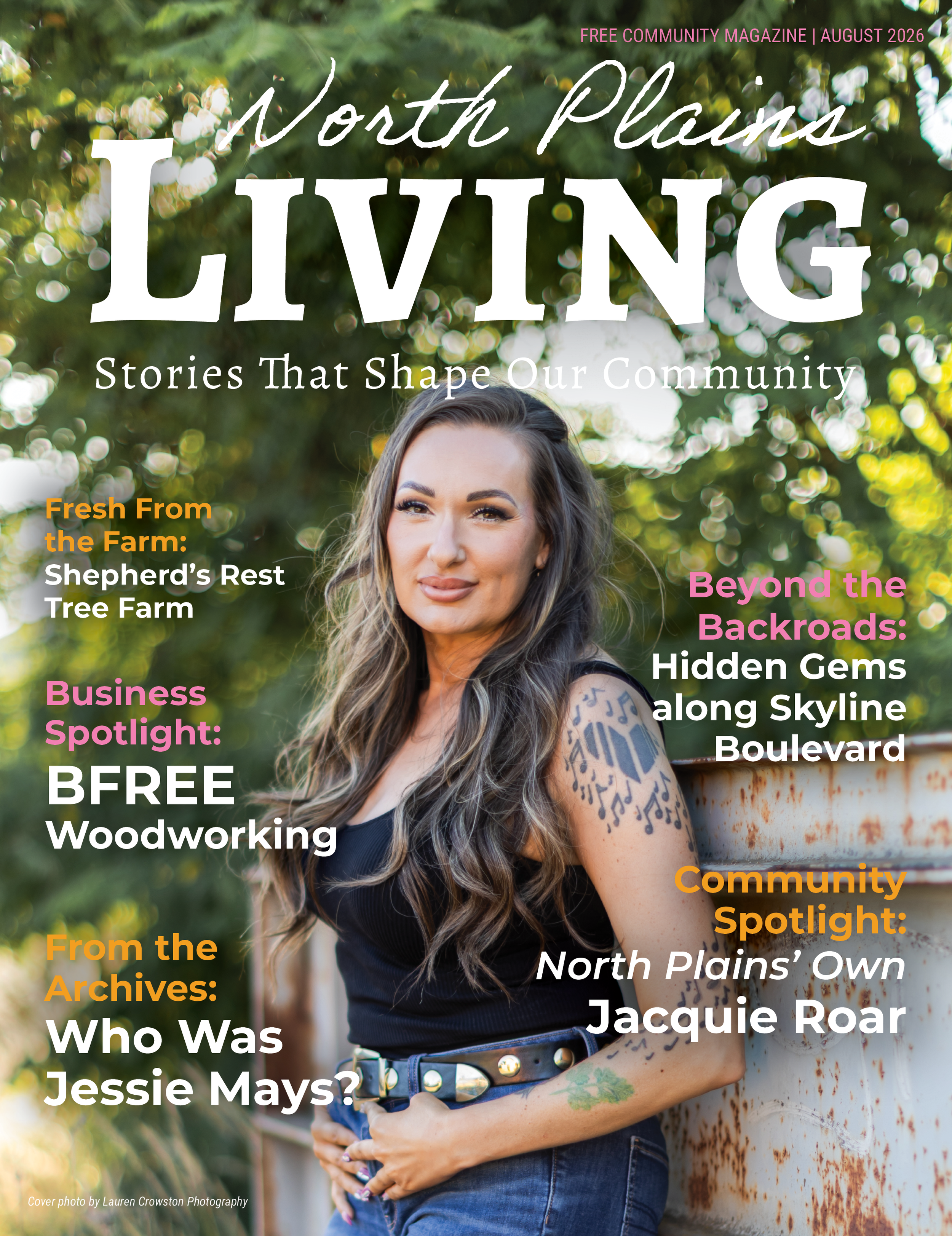 Cover of North Plains Life magazine, August 2026, featuring a woman with tattoos and long wavy hair leaning against a rusty metal surface, with a background of greenery and bokeh effects. The cover includes headlines about community stories, a business spotlight, and historical archives.