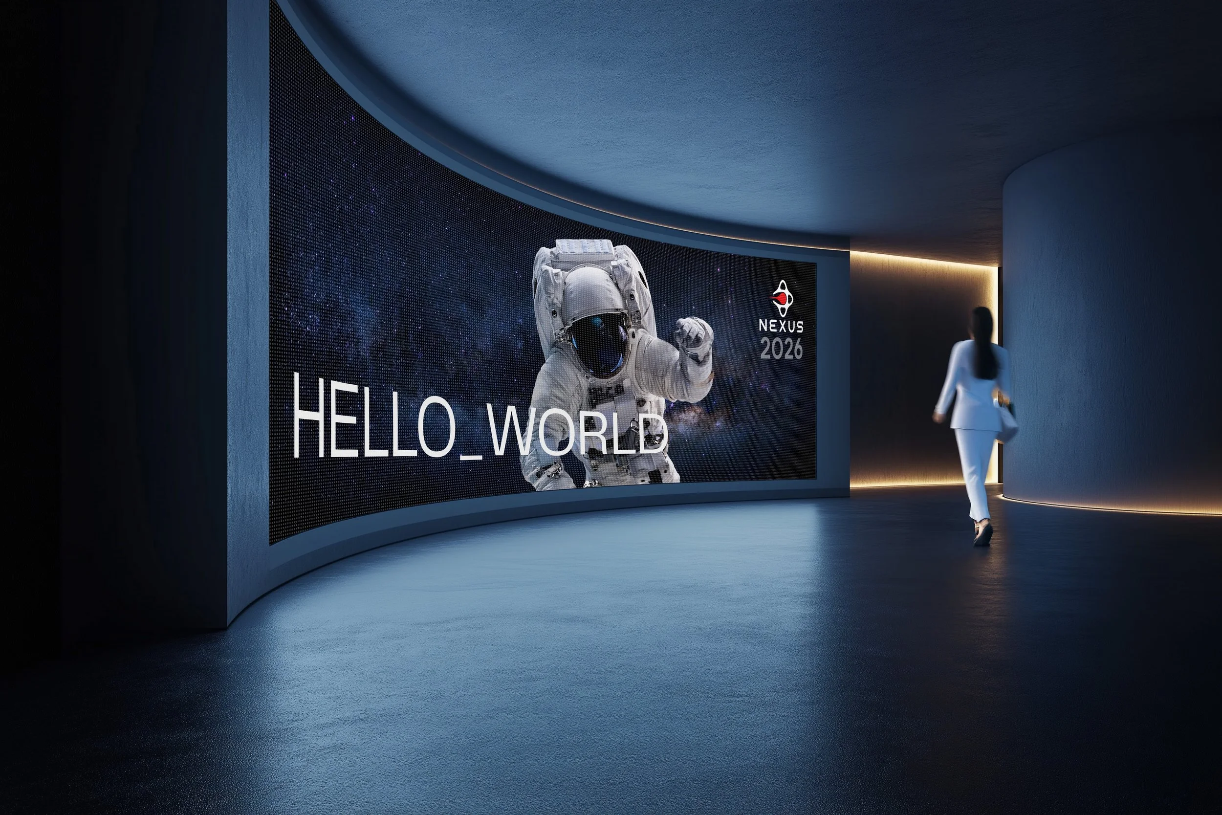 A woman in white business attire walking past a large curved digital screen in a modern, dark corridor. The screen displays an astronaut in space with the text "HELLO_WORLD," and logos for NEXUS 2026.
