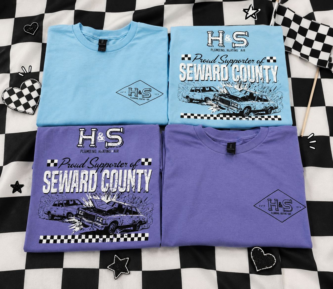 Four screen-printed T-shirts with automotive and plumbing branding, four cloth flags, and star and heart patches on a black and white checkered fabric background.