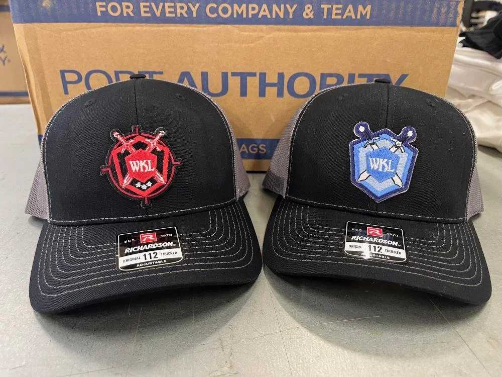 Embroidered patches on the front of Richardson hats for White Knight Labs.