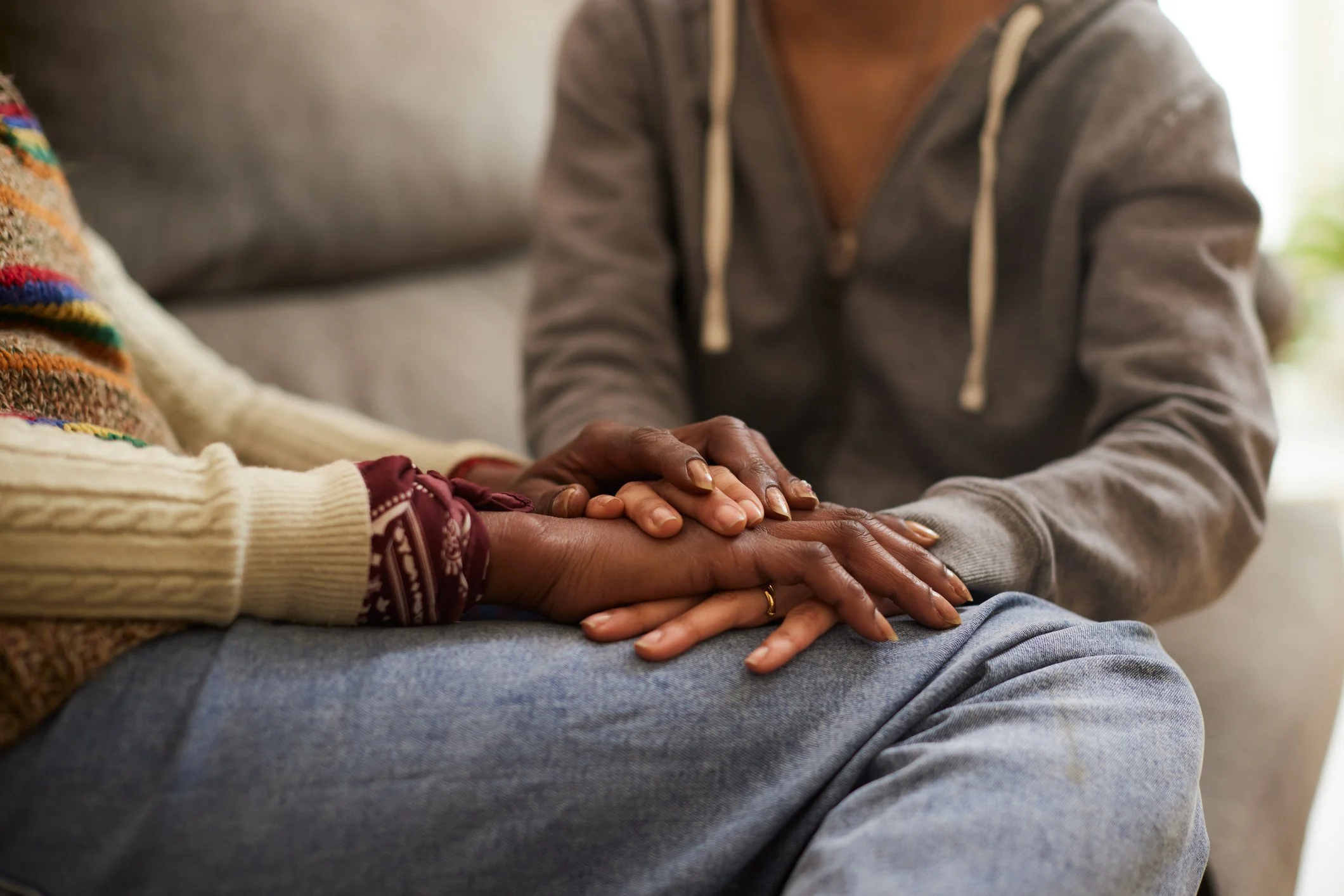 People holding hands during a comforting or reassuring moment.