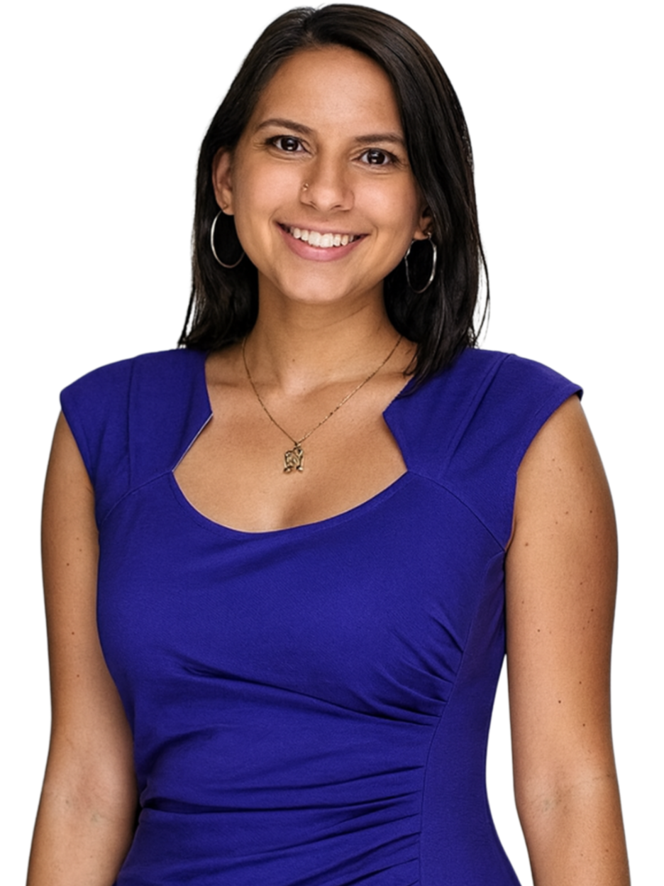 A woman smiling, wearing a royal blue sleeveless dress with a gold necklace and hoop earrings.