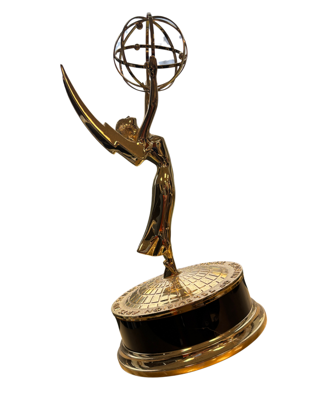 A golden Emmy Award trophy featuring a winged woman holding an atom, standing on a circular base.