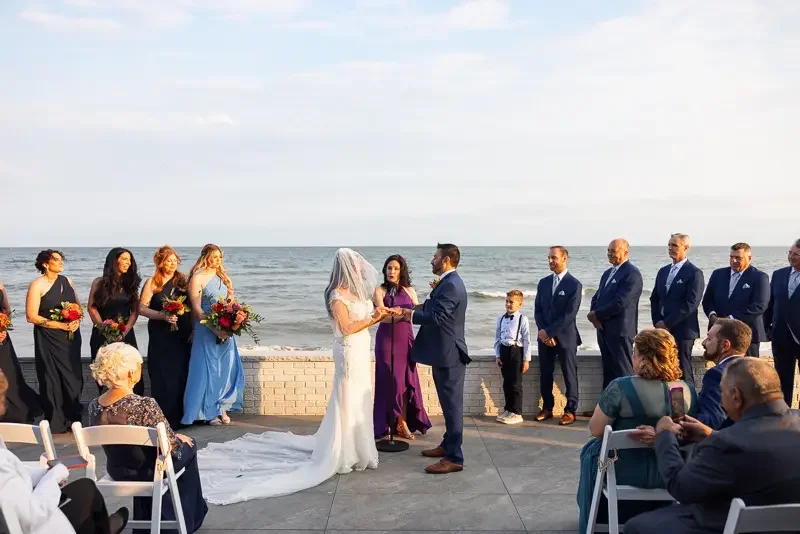 Oceanfront wedding ceremony with guests