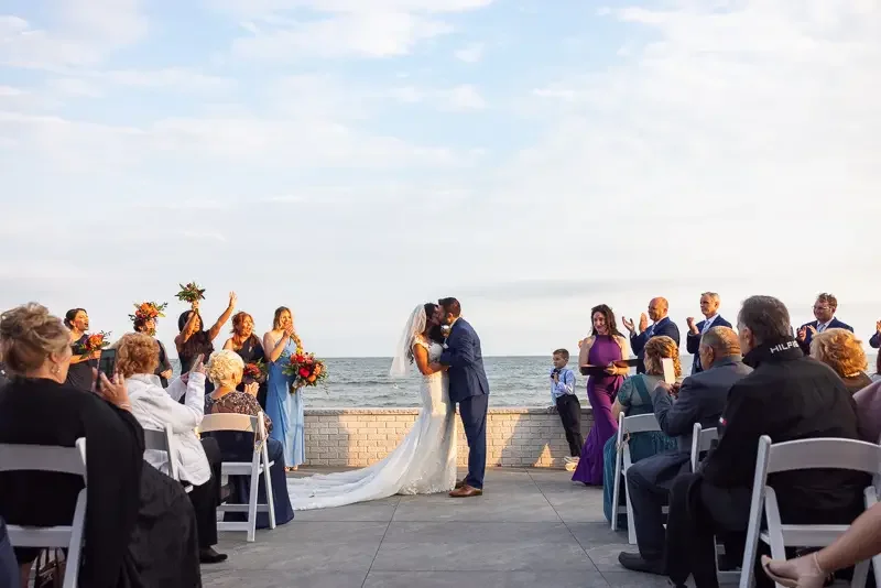First kiss at oceanfront wedding