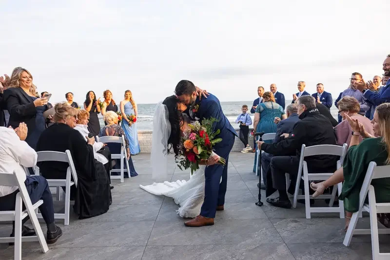 Couple kisses during wedding recessional