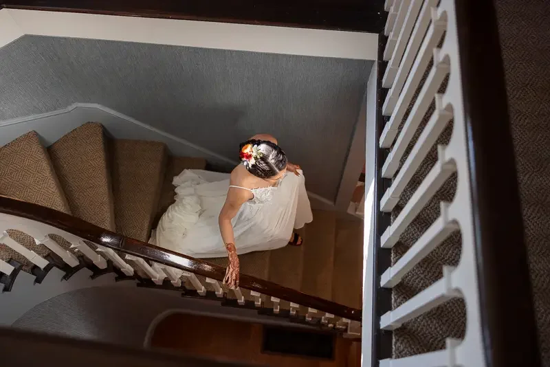 Bride on staircase at Saint Clements Castle wedding