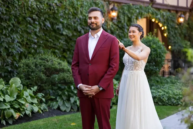 Bride taps groom on the shoulder during a first look at Saint Clements Castle