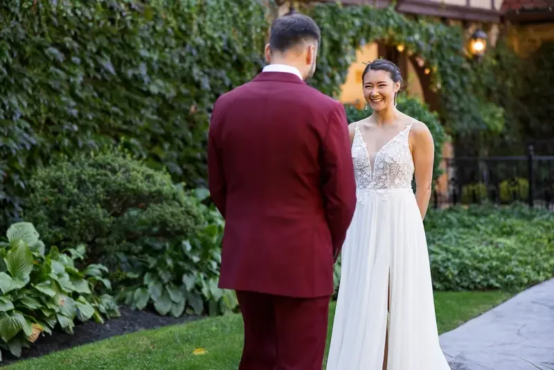 Groom turns around smiling during first look at Saint Clements Castle