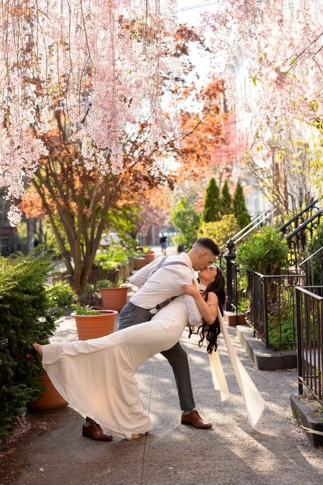 Couple dipping kiss under cherry blossoms in New Haven