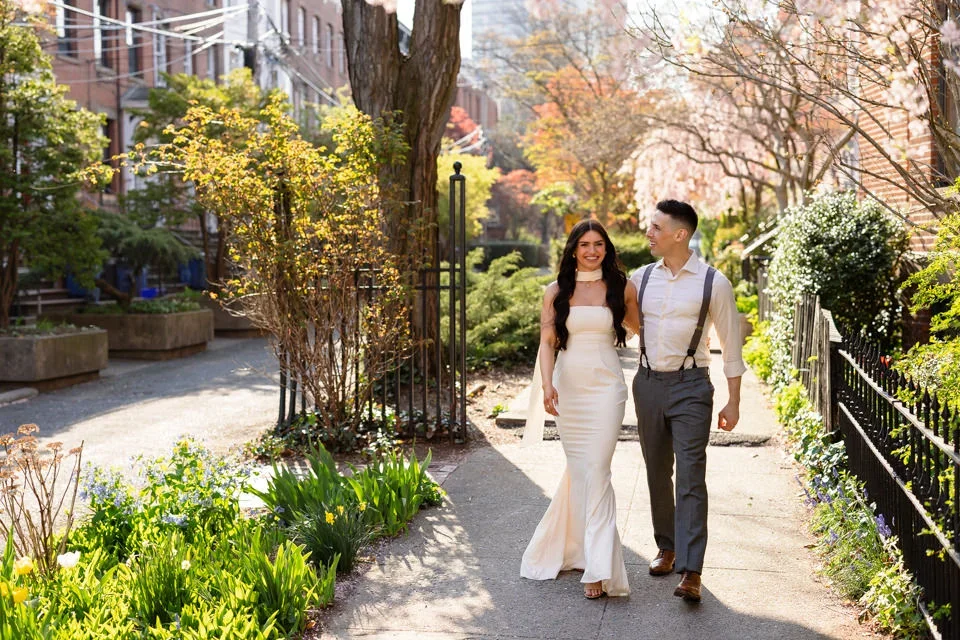 Couple walking arm in arm through Wooster Square Park in spring
